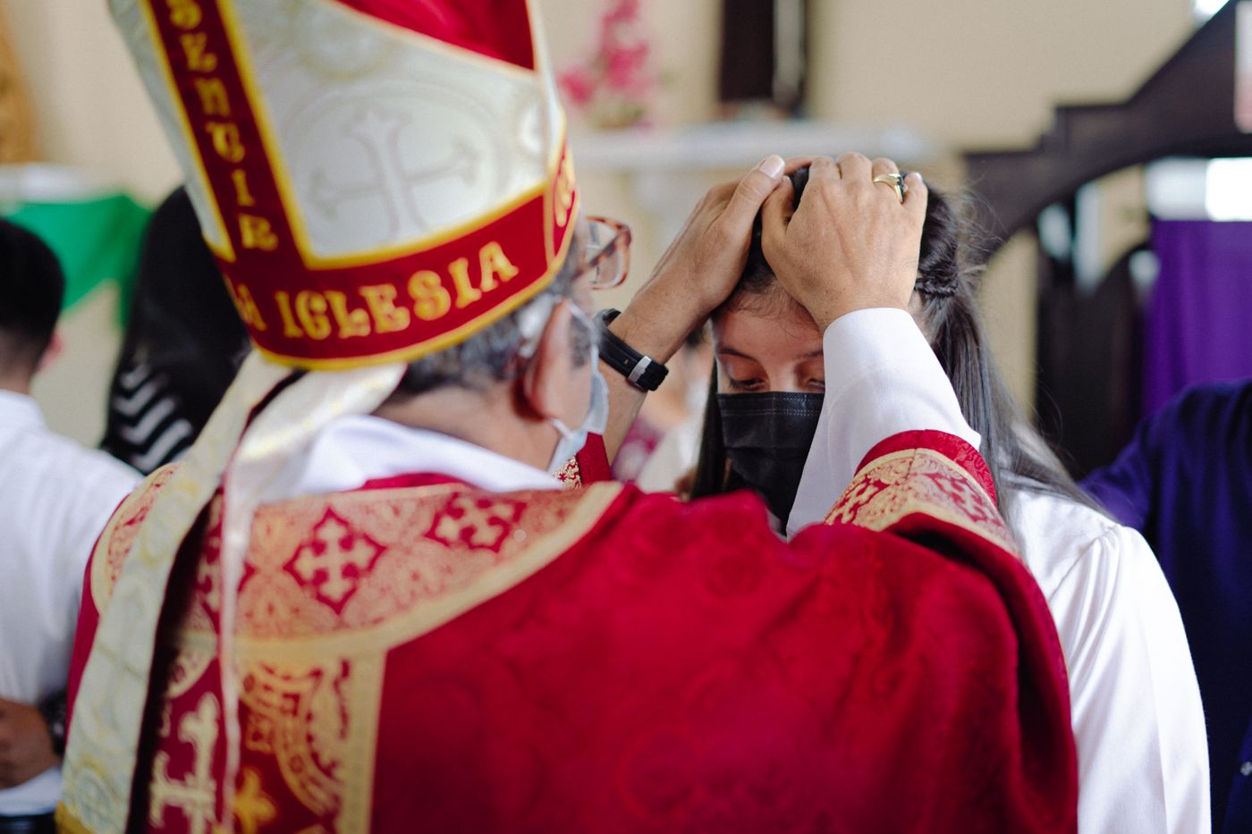 A bishop blessing a young person during Confirmation